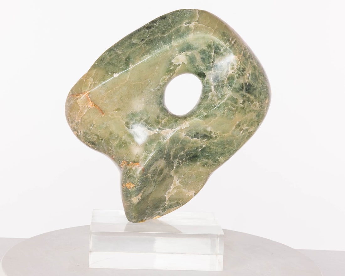 Abstract Green Stone Sculpture, Unsigned: Property from a Private Collection, New York City Description: Abstract Green Stone Sculpture, Unsigned, on a Lucite rectangular base. Measurements: Height: of sculpture 12 in. x Width: 12 in.? x