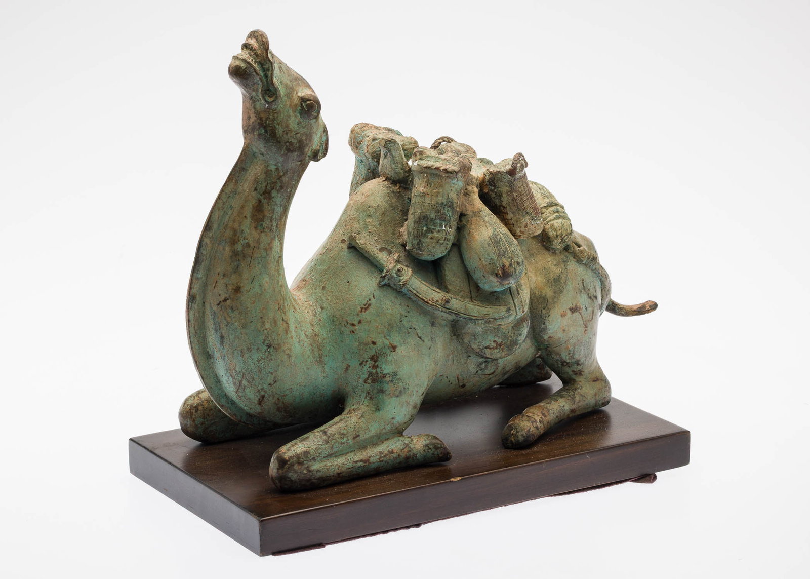 Metal Camel: Property from a Private Collector, Savannah, GA Description: Metal Camel, kneeling on wood pedestal. Measurements: Height: 13 in. x Width: 15 in. x Depth: 8 in.