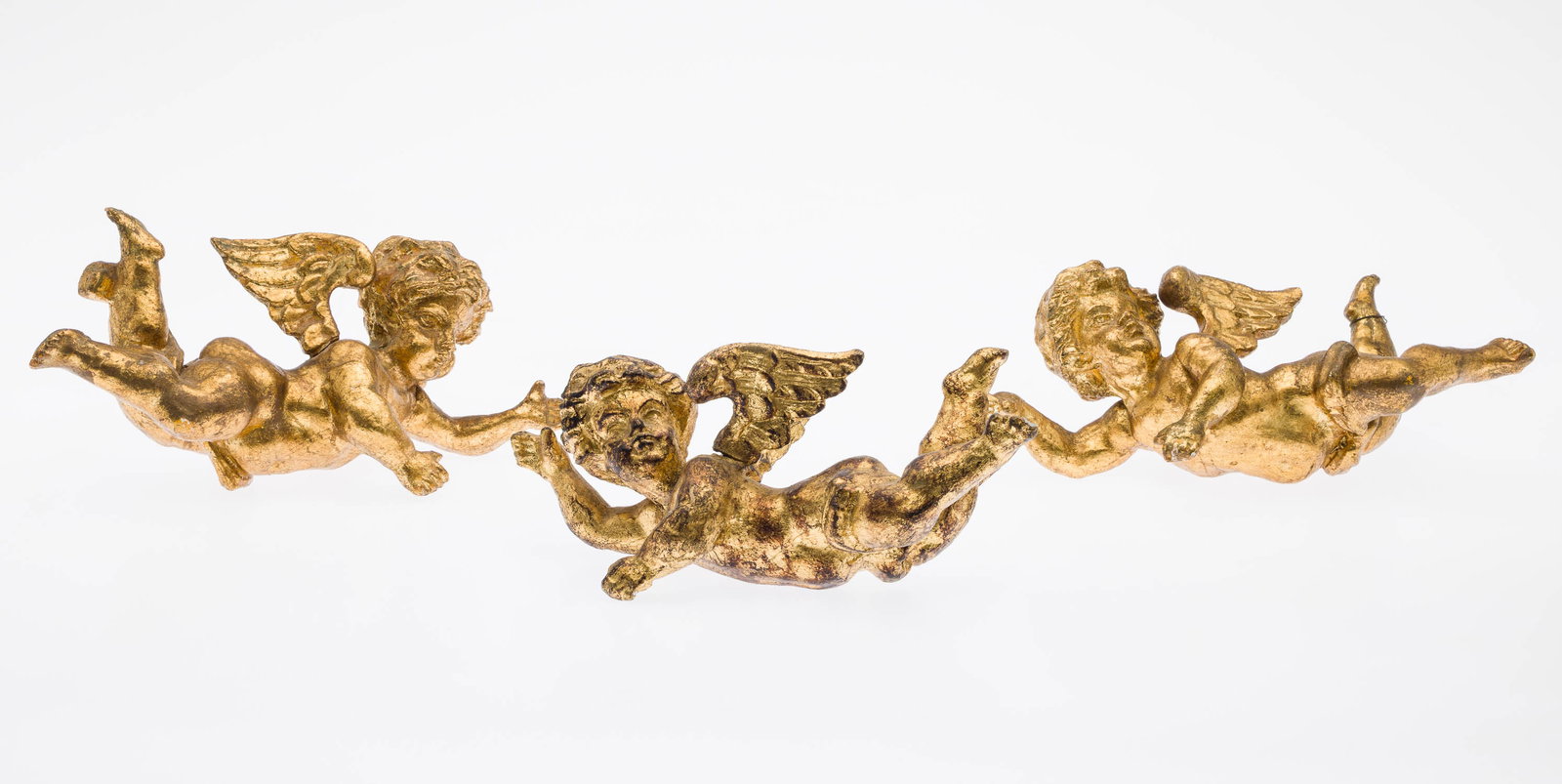 3 Giltwood Cherubs: Description: 3 Giltwood Cherubs, three similar giltwood cherubs, each in flight with extended arms and legs. Measurements: Height: approx. of each 4 1/4 in. x Width: 10 in. x Depth: 5 in.