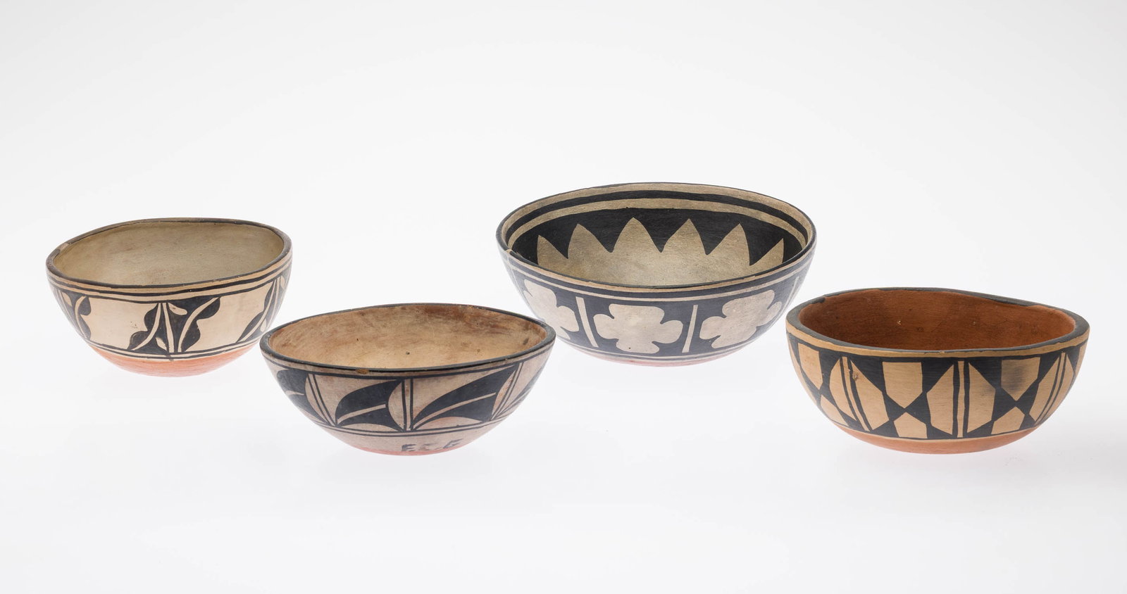 4 Santo Domingo Black on White Bowls, 20th Century: Property of Bliss Hebert and Allen Charles Klein Description: 4 Santo Domingo Black on White Bowls, 20th Century, of various sizes and decorations. The largest with painted interior and band of fo
