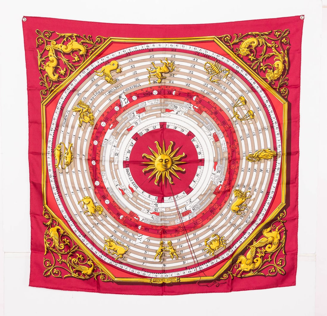 Hermes 'Astrologie Dies et Hore' Silk Scarf: Description: Hermes 'Astrologie Dies et Hore' Silk Scarf, signed by F. Raconnet, depicting a central gold sun surrounded by concentric rings with red border. Measurements: Height: 35 in. x Width: 35