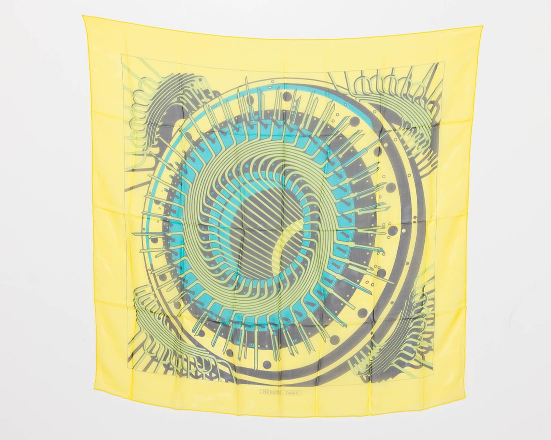 Hermes Alternateur Silk Scarf: Description: Hermes Alternateur Silk Scarf, designed by Pierre Peron in 1971, depicting electric generator, with yellow border. Measurements: Height: 35 in. x Width: 35 in.