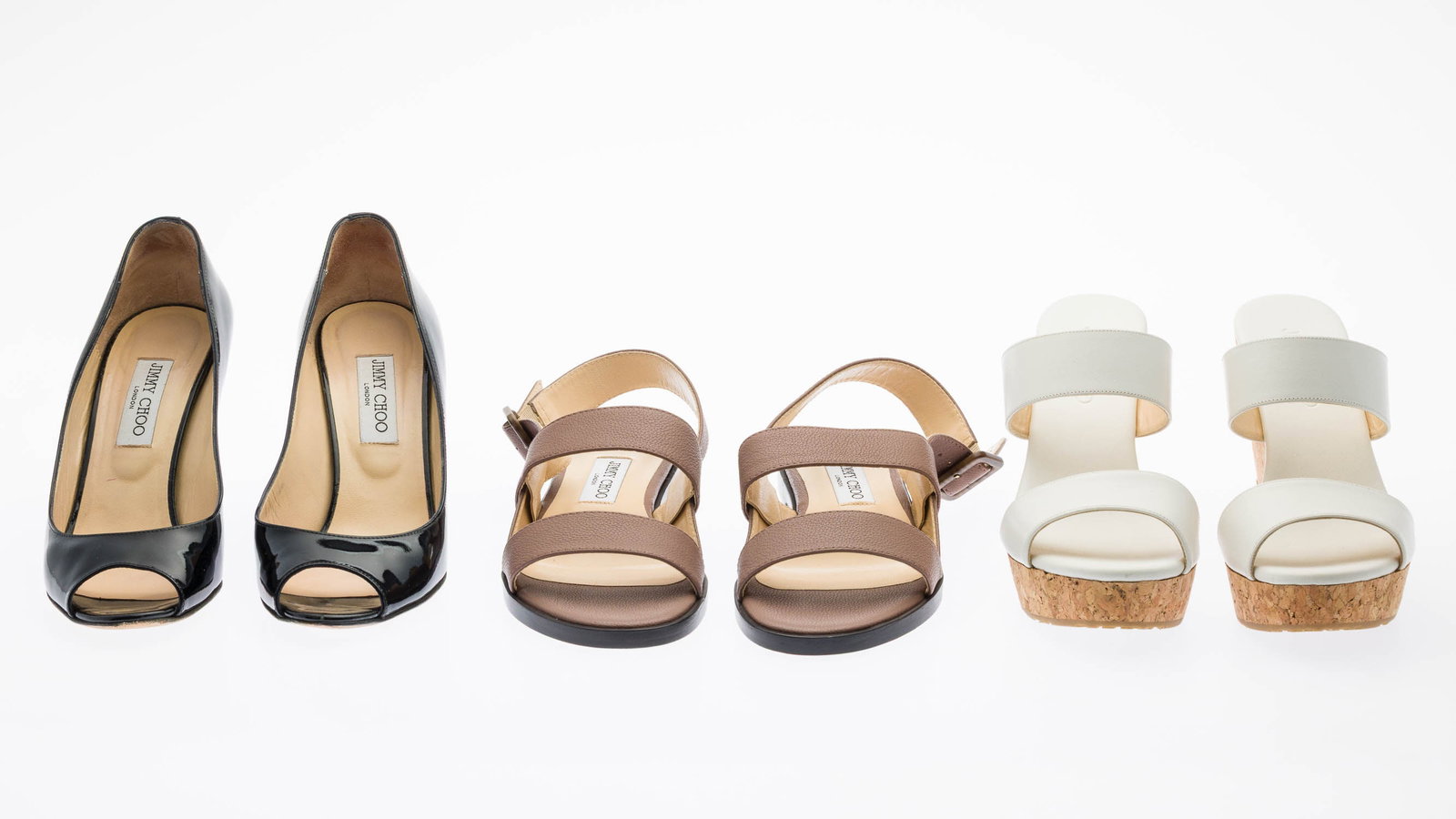 3 Pairs of Jimmy Choo Shoes: Description: 3 Pairs of Jimmy Choo Shoes, comprising Baxen black patent leather peep toe wedge pumps, 3 1/2 in. heel (size 39 1/2); nude leather strappy flat sandals (size 38 1/2); and Prisma cork