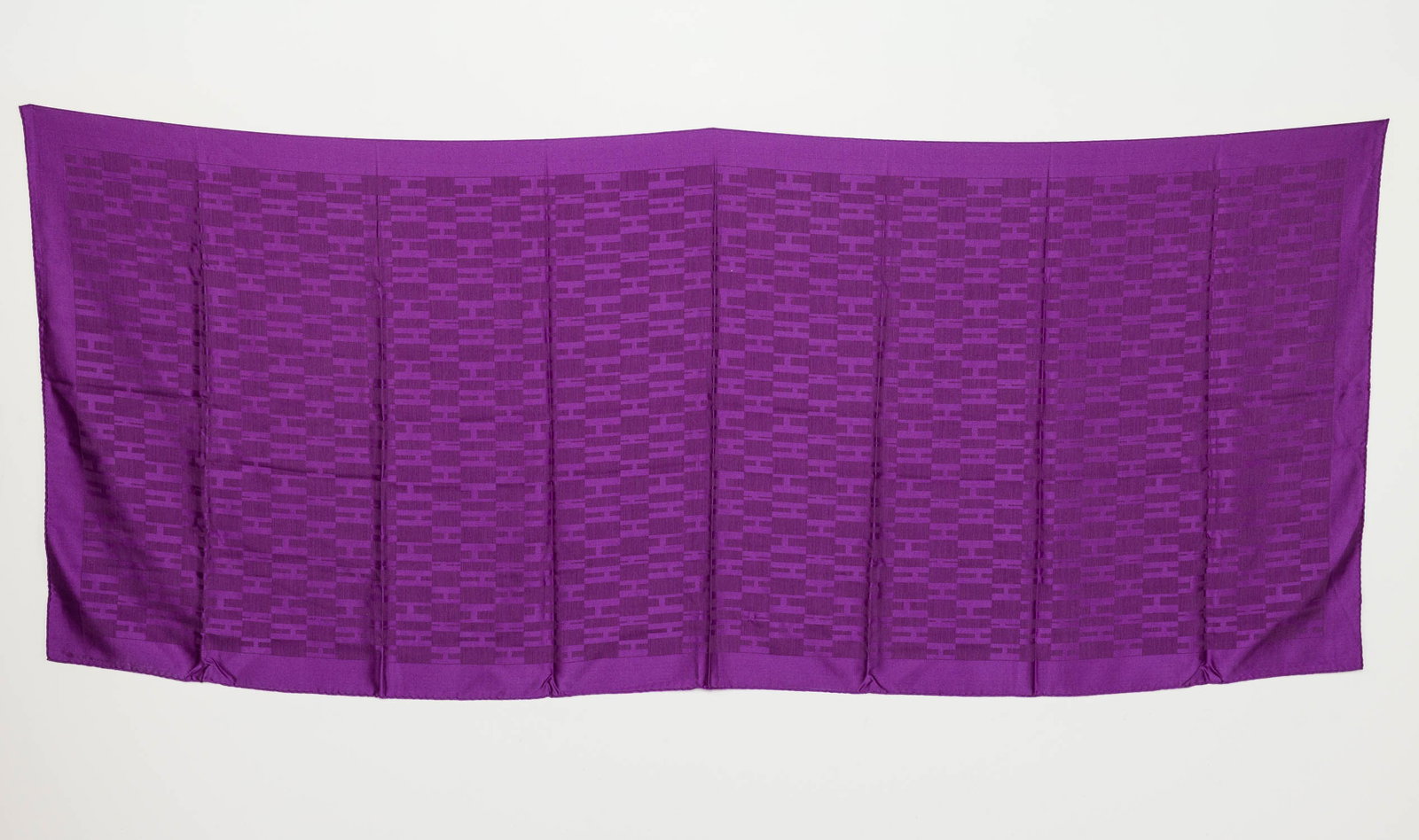 Purple Hermes Silk Scarf: Description: Purple Hermes Silk Scarf, featuring the iconic "H" logo motif in tones of rich purple. Measurements: Height: 70 1/2 in. x Width: 29 1/2 in.