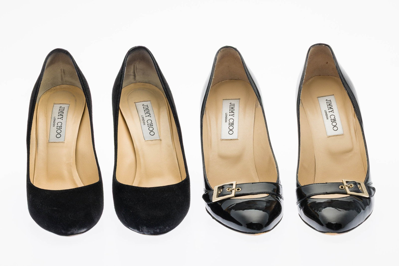 Two Pairs of Jimmy Choo Heels: Description: Two Pairs of Jimmy Choo Heels, comprising a pair of classic black suede pumps with softly rounded toe box and stiletto 4 in. heel; and black patent leather pumps with gold-tone buckle