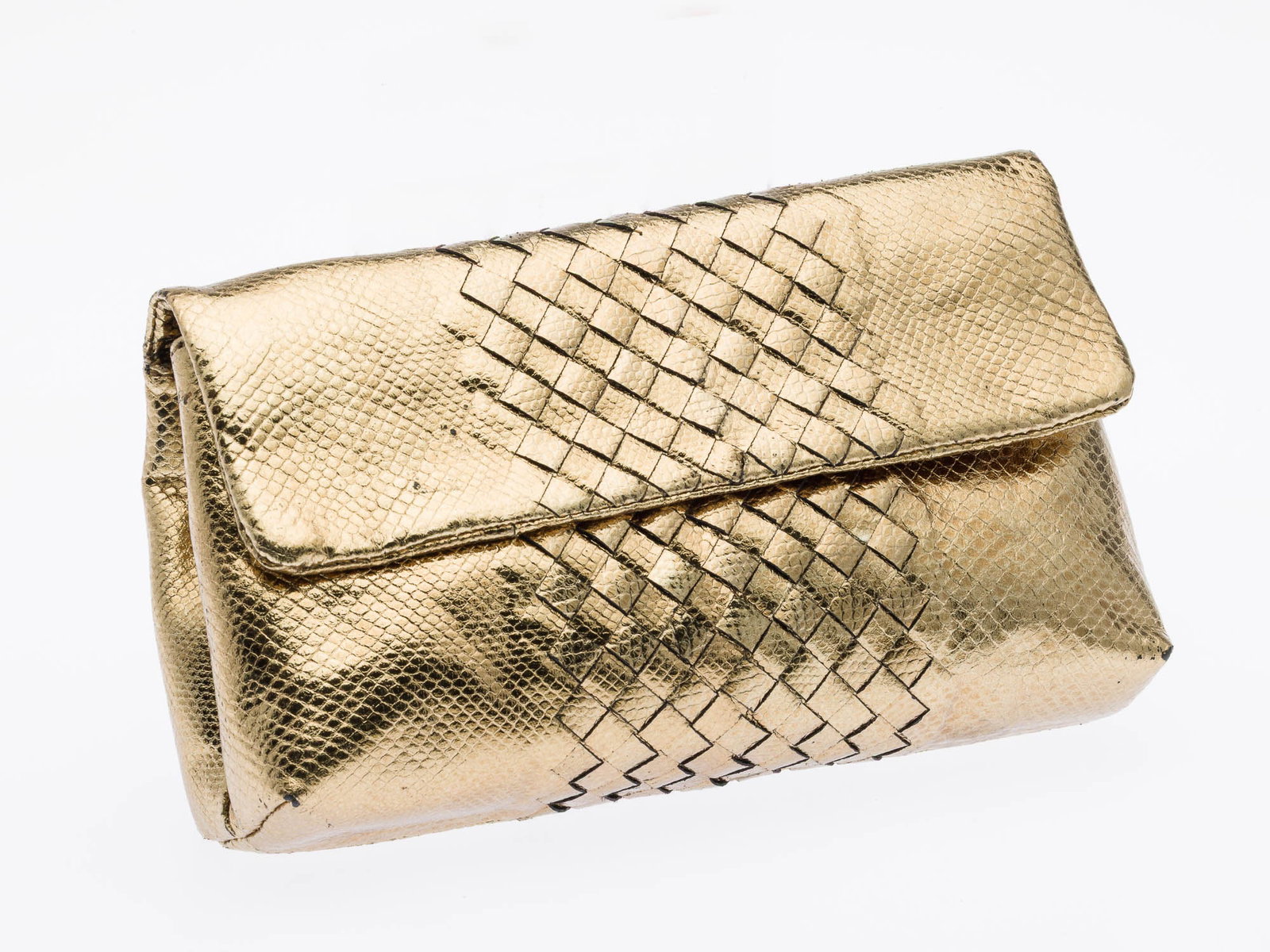 Bottega Veneta Gold Leather Clutch: Description: Bottega Veneta Gold Leather Clutch, with a metallic python pattern and the brand's signature intrecciato pattern on the front flap closure, with internal zippered pocket and leather tab.