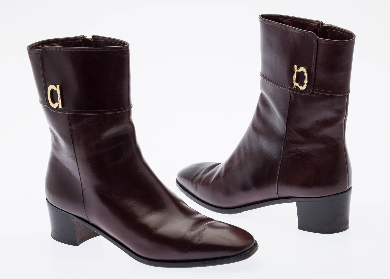 Pair of Brown Leather Ferragamo Ankle Boots: Description: Pair of Brown Leather Ferragamo Ankle Boots, with signature gold-tone Gancini buckle ornament at the ankle collar, with side zipper closure and stacked leather block 2 in. heel.