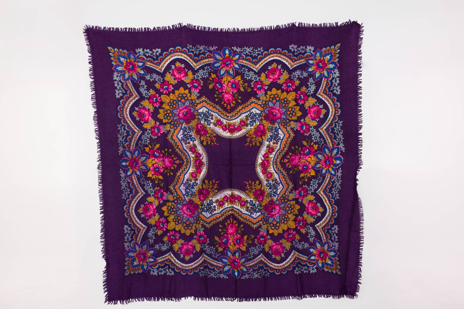 Eric Bompard Cashmere Scarf: Description: Eric Bompard Cashmere Scarf, tagged at the corner, with symmetrical floral pattern in tones of deep purple, pink, and green, with short fringe. Measurements: Height: 45 in. x Width: 45