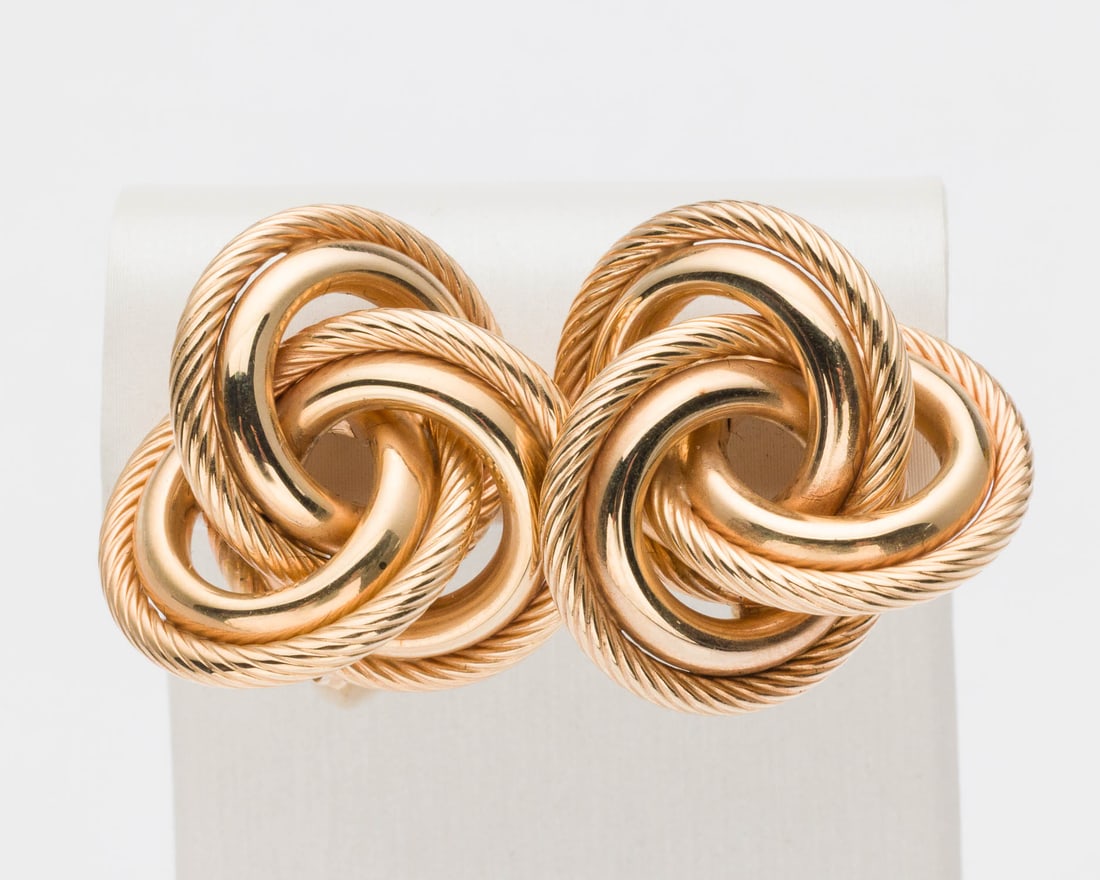 Pair of 14K Gold Love Knot Earrings: Description: Pair of 14K Gold Love Knot Earrings, a pair of knot-form earrings with post and clip backs, both marked '14K' near clips. 10.65 grams overall. Measurements: Height: 1 in. x Width: 1 in.