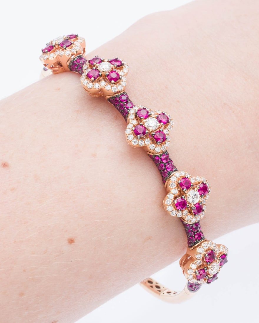 18K Gold, Diamond and Spinel Bangle Bracelet: Description: 18K Gold, Diamond and Spinel Bangle Bracelet, featuring numerous pave and bead set red spinel and diamonds with flower motifs on a flexible rose gold band, marked '18K, 750' and '1.63,
