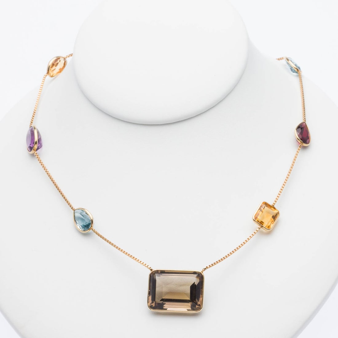 Multi Gem and 14K Gold Necklace: Property from a Private Collection, Savannah, GA Description: Multi Gem and 14K Gold Necklace, featuring various faceted gemstones including amethyst, garnet, topaz, and citrine with bezel settings