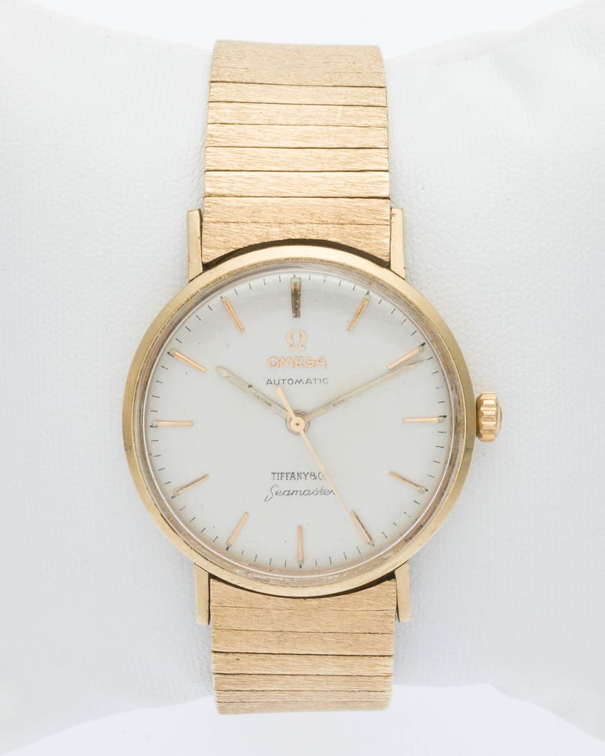 14K Omega Seamaster Men's Watch Retailed by Tiffany: Property from a Private Collection, Savannah, GA Description: 14K Gold Omega Seamaster Men's Watch, Retailed by Tiffany, with circular white face, marked 'Omega, Automatic, Tiffany & Co, Seamaster