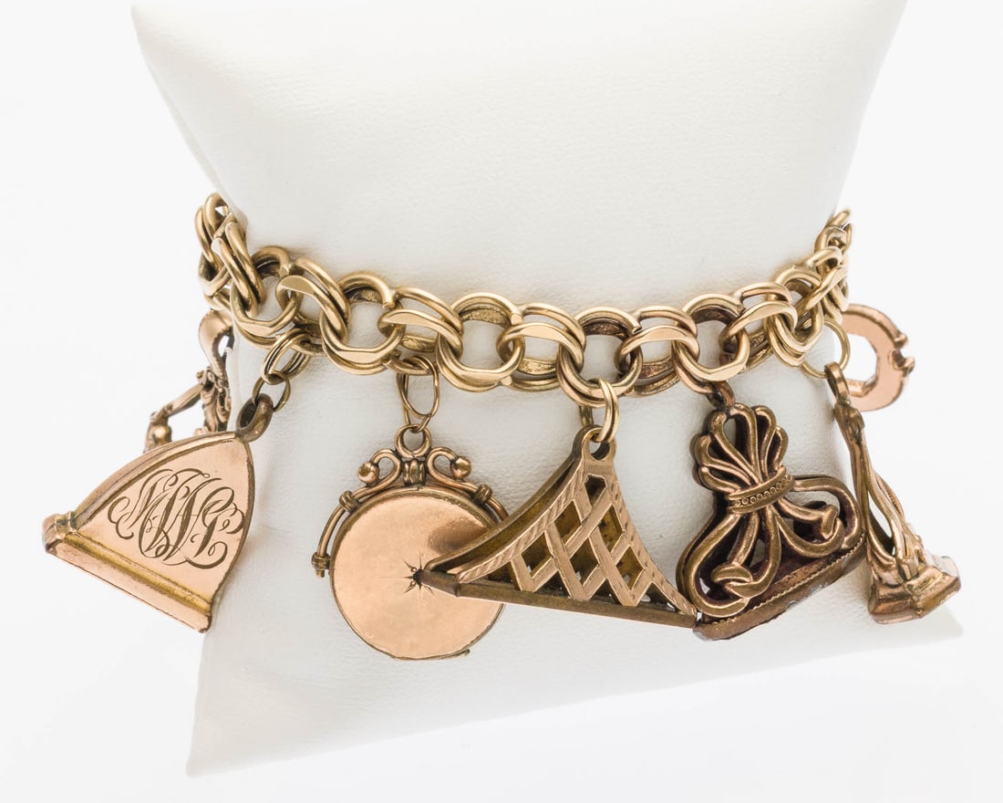 14K Gold Charm Bracelet: Property of a Private Collector, Savannah, GA Description: 14K Gold Charm Bracelet, 14K gold double-link chain with box clasp (marked '14K'), with 8 various unmarked charms and fobs. 60.05 grams o
