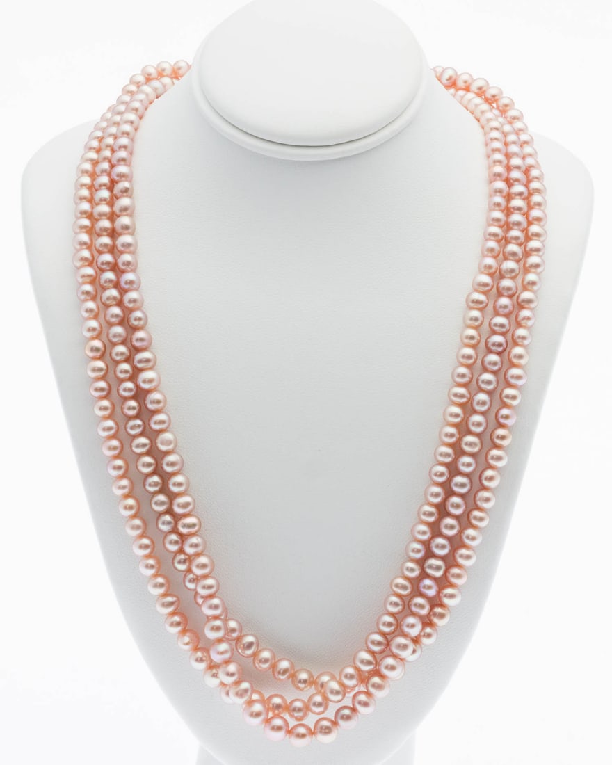 Three Strand Pink Pearl Necklace: Property from a Private Collection, Jacksonville, FL Description: Three Strand Pink Pearl Necklace, three strands of graduated pink pearls, ranging from approx. 4-6 mm, with silver box clasp, mark