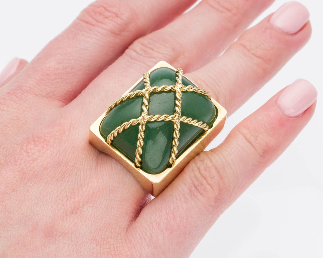 Seaman Schepps 18K and Nephrite Ring, Size 6: Description: Seaman Schepps 18K and Nephrite Ring, Size 6, 18K yellow gold ring featuring a green nephrite cabochon with gold cage design overtop, marked '18K' on inside of band. 40.47 grams overall.