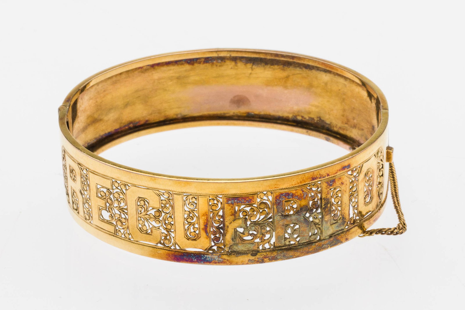 10K Pierce Work Lovers Cuff Bracelet: Property of a Private Collector, Savannah, GA Description: 10K Pierce Work Lovers Cuff Bracelet, finely pierced along front 'Recuerdo' (Remember), with hinge and clasp with safety chain, unmarked but