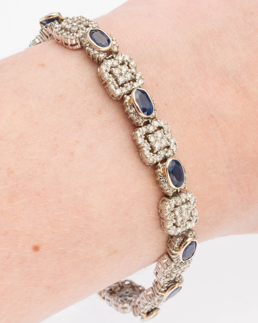 Sapphire and Diamond 14K Bracelet: Description: Sapphire and Diamond 14K Bracelet, featuring oval cut blue sapphires (approx. 7 cts) bezel set with diamond halos, alternating with square links set with round diamonds ( approx. 5 cts),