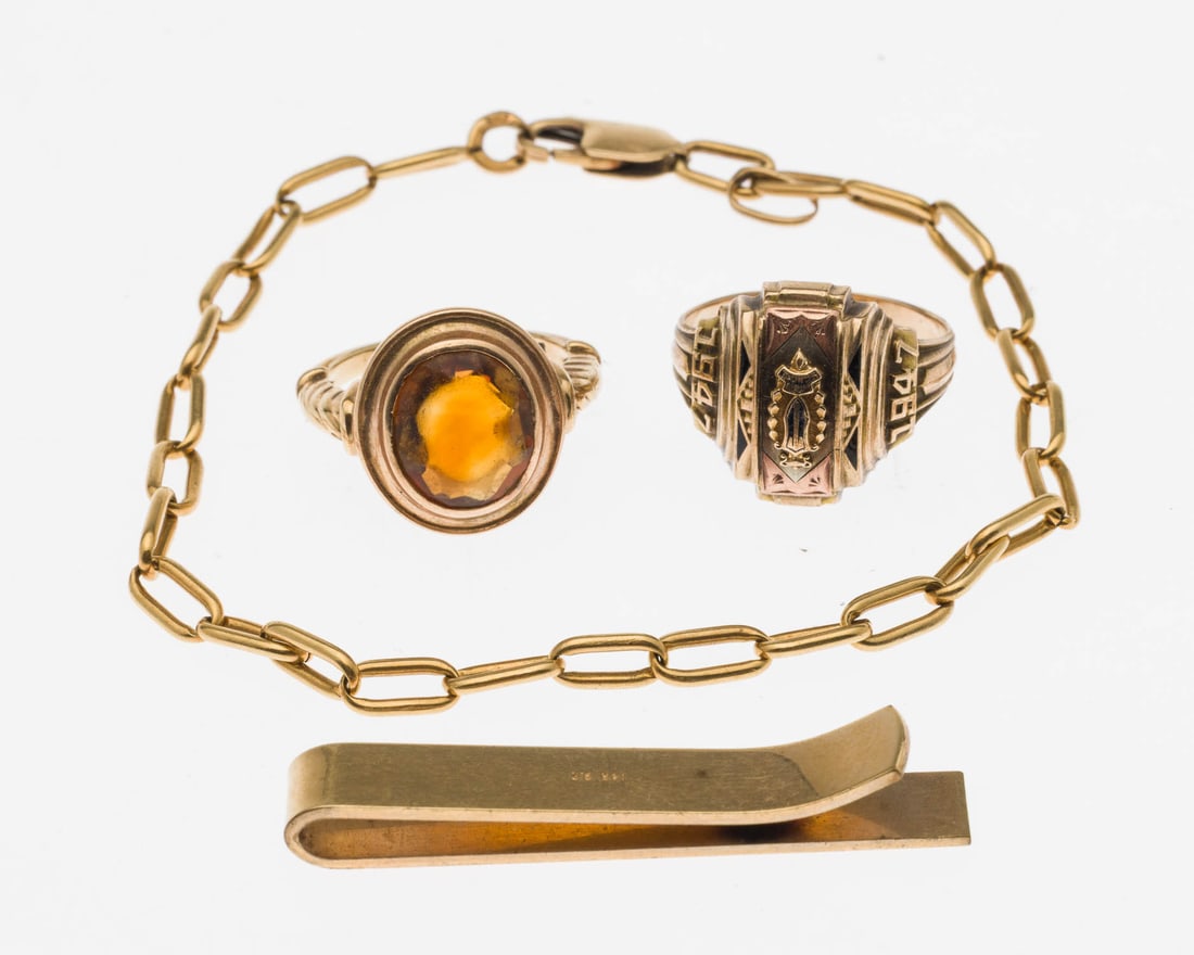 2 Gold Rings and a Bracelet & Gold Filled Tie Clip: Property of Bliss Hebert and Allen Charles Klein Description: 14K and Citrine Ring, 10K ring, 18K Bracelet and Gold Filled Tie Clip, comprising a gold filled tie clip (marked '14K, GF'), a 14K gold