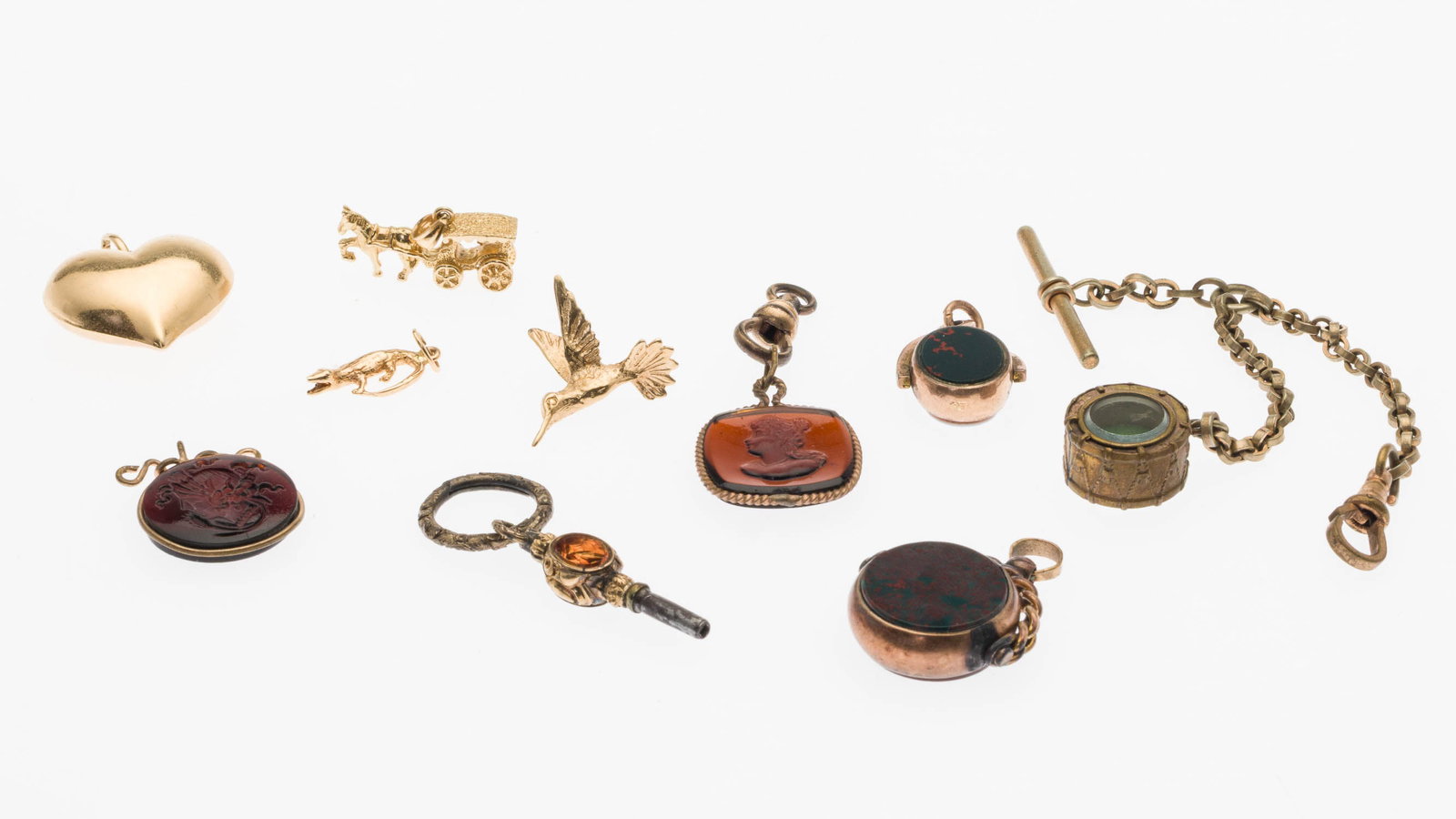 Group of 10K and 14K Gold Charms, 10 pcs.: Property of a Private Collector, Savannah, GA Description: Group of 10K and 14K Gold Charms, 10 pcs., comprising a 14K alligator charm (marked); a 14K hummingbird charm (marked); a 14K horse and
