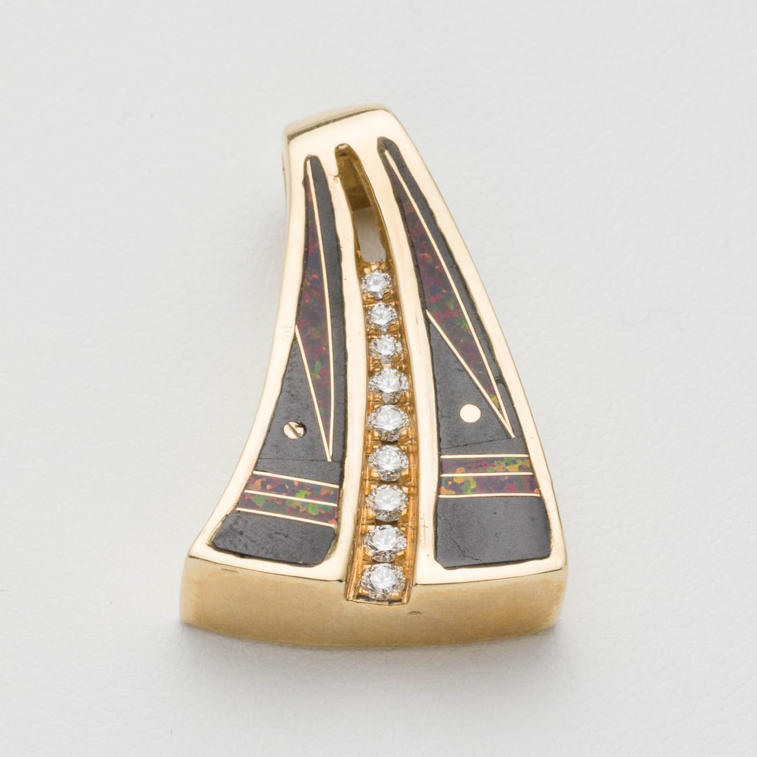 14K Gold Onyx, Red Opal and Diamond Pendant: Description: 14K Gold Onyx, Red Opal and Diamond Pendant, inlaid with black onyx and red opal, featuring 9 graduated round diamonds, set in 14K yellow gold, marked '14Kt' on back. 9.53 grams.