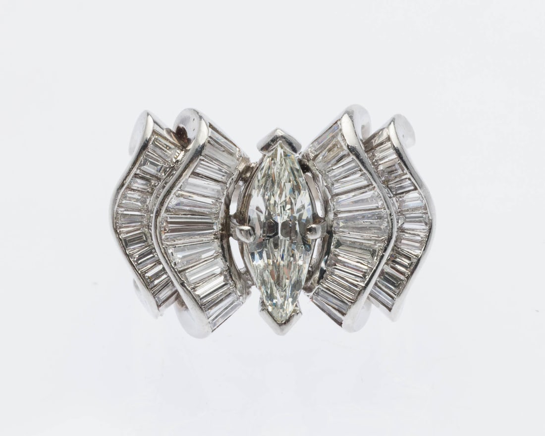 Unique Marquise Diamond & Platinum Ring, Size 5.25: Description: Unique Marquise Diamond and Platinum Ring, Size 5.25, featuring central marquise diamond (approx. 1.0 cts, G-H, VS) flanked by two ribbons of baguettes (approx. 0.75 cts F-VS) set in