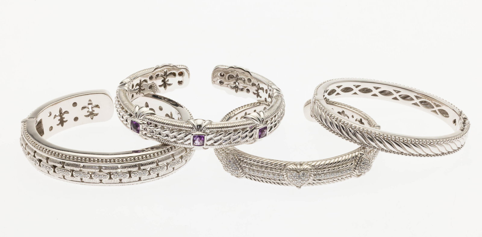 Four Judith Ribke Sterling Silver Cuffs: Property from a Private Collection, Savannah, GA Description: Four Judith Ribke Sterling Silver Cuffs, two cuffs featuring CZ crystals, one featuring amethysts, all marked 'Judith Ripka, 925, Thai
