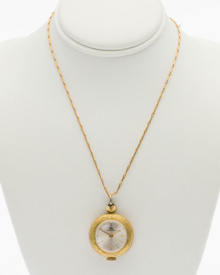 10K Bucherer Watch Pendant on Chain: Property from a Private Collection, Jacksonville, FL Description: 10K Bucherer Watch Pendant on Chain, with silver-tone face marked 'Bucherer' in a round brushed yellow gold case on a 18K gold cha
