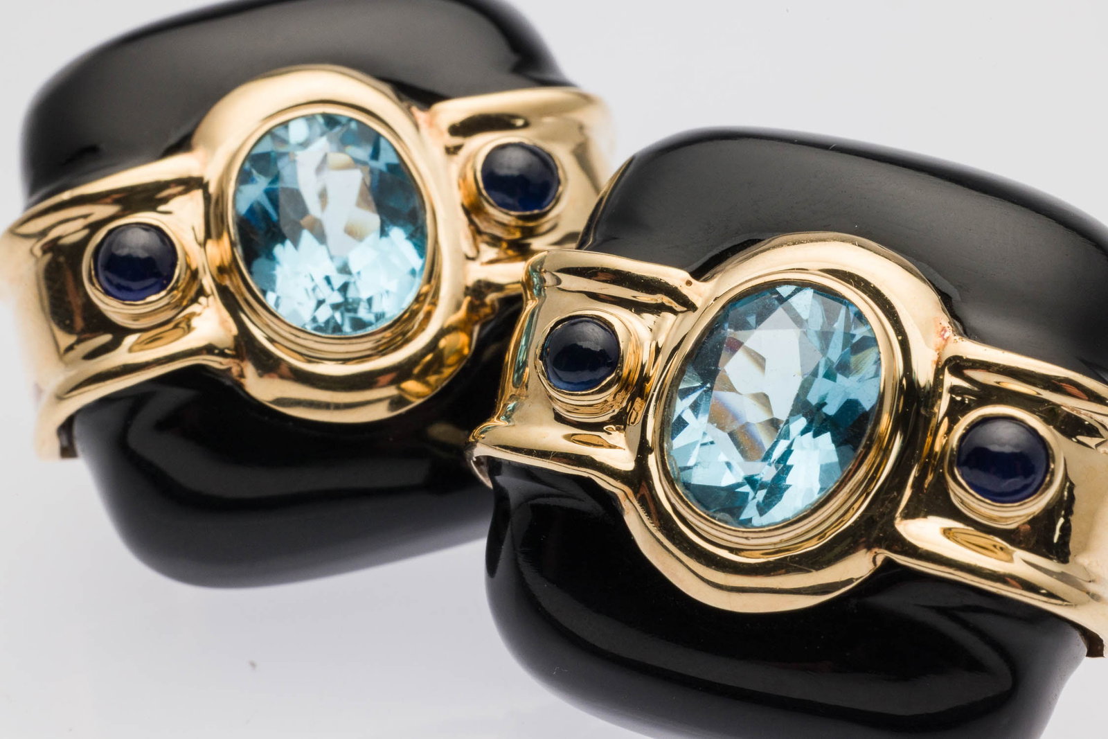 Pair of Onyx and Blue Topaz 14K Earrings: Property from a Private Collection, Jacksonville, FL Description: Pair of Onyx and Blue Topaz 14K Earrings, the square onyx earrings featuring oval blue topaz bezel mounted in center and flanked by