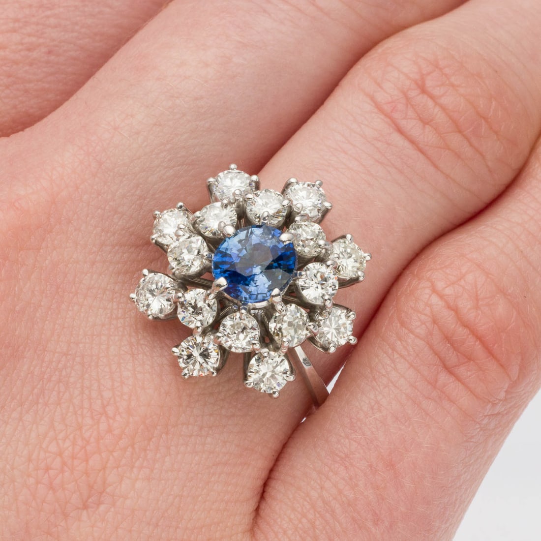Sapphire (3 cts) and Diamond Ring, Size 8.5: Description: Sapphire (3 cts) and Diamond Ring, Size 8.5, featuring a central Sapphire (approx. 6.9 mm, 3 cts) with cluster of round Diamonds (approx. 3.4-3.2mm G-H, VS1-VS2) prong set in white gold