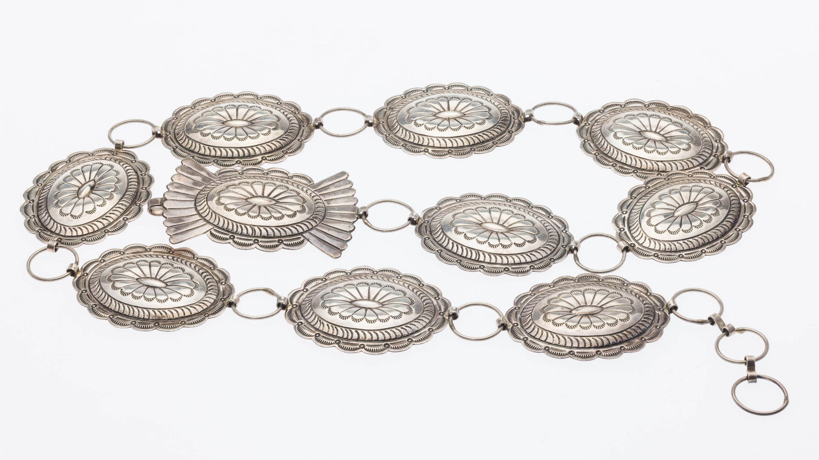 Sterling Silver Concha Belt: Property of a Private Collector, Savannah, GA Description: Sterling Silver Concha Belt, with 9 panels and a buckle, marked 'S. James Sterling on back of buckle. 7.15 troy ounces. Measurements:
