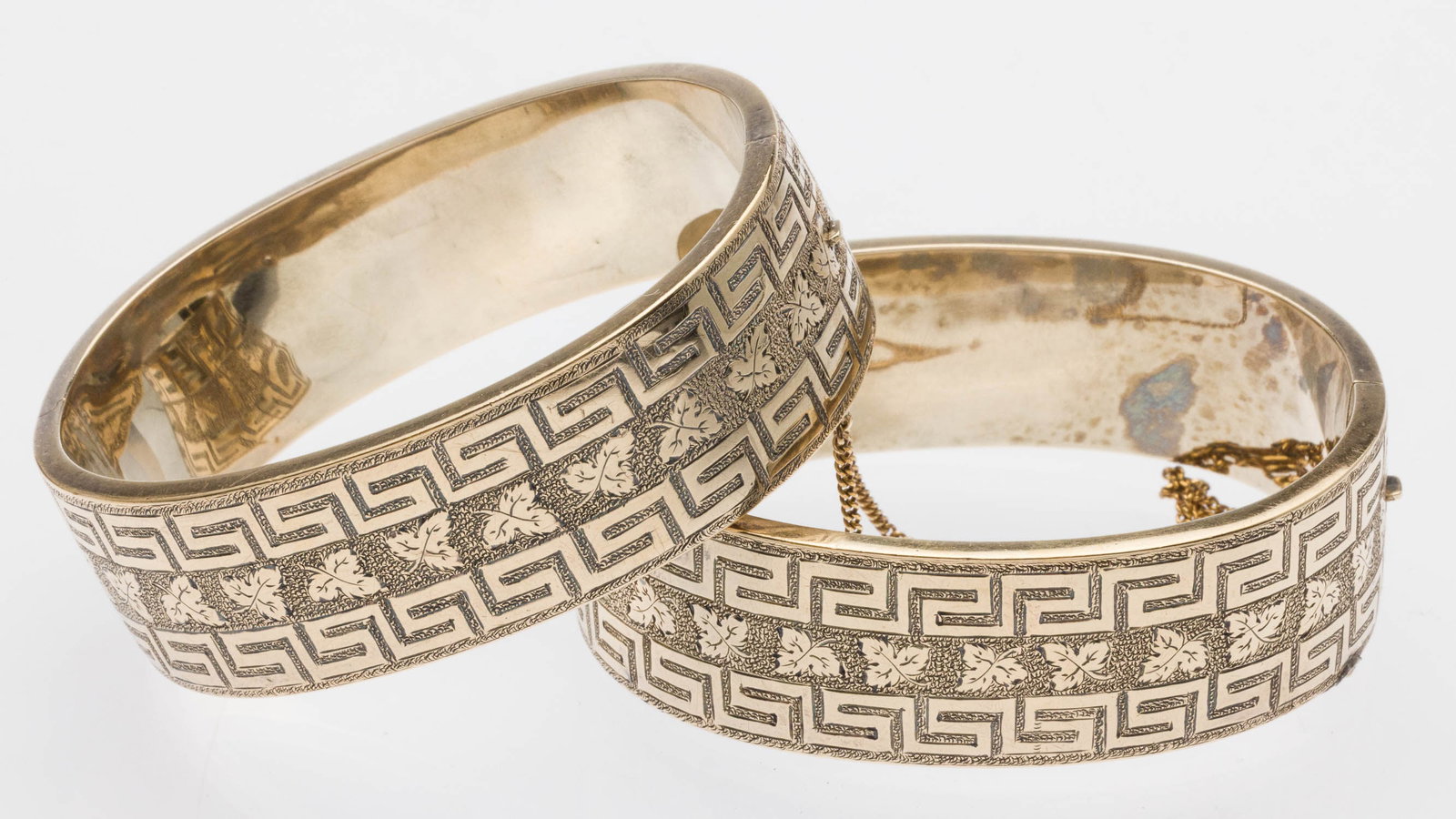Pair of Sterling Silver Cuff Bracelets in Box: Property from a Private Collection, Savannah, GA Description: Pair of Sterling Silver Cuff Bracelets in Box, each with engraved Greek key and grape vine motif, with hinge and box clasp with safety