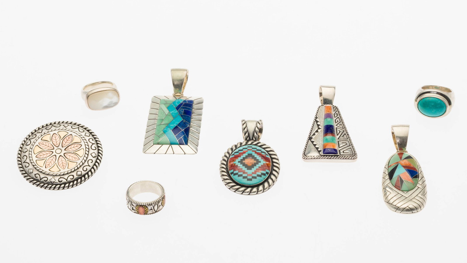 Group of Sterling Silver & Turquoise Jewelry, 8 pcs: Property from a Private Collection, Savannah, GA Description: Group of Sterling Silver and Turquoise Jewelry, 8 pcs, comprising 4 sterling silver pendants featuring various inlaid designs in lapis,