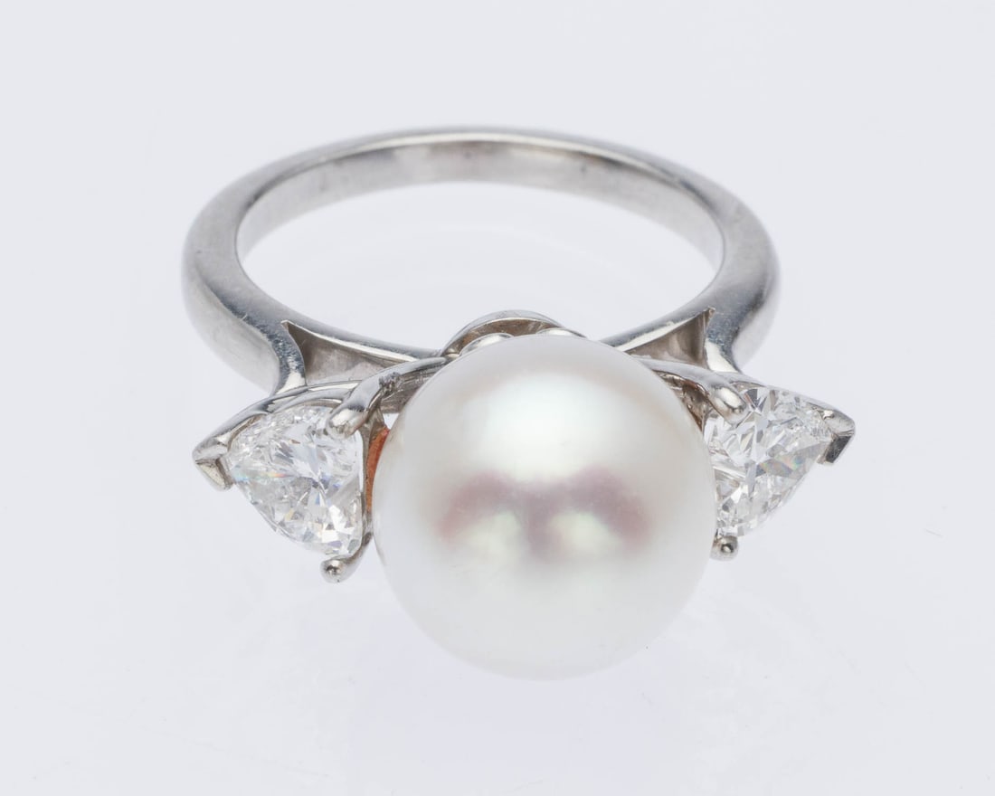 Pearl and Diamond 18K Ring, Size 7.5: Description: Pearl and Diamond 18K Ring, Size 7.5, featuring an approx. 11.5 mm pearl flanked by heart cut diamonds (approx. 1.5 cts, F-G, VVS-VS) set in white gold, unmarked but tests 18K. 10.31