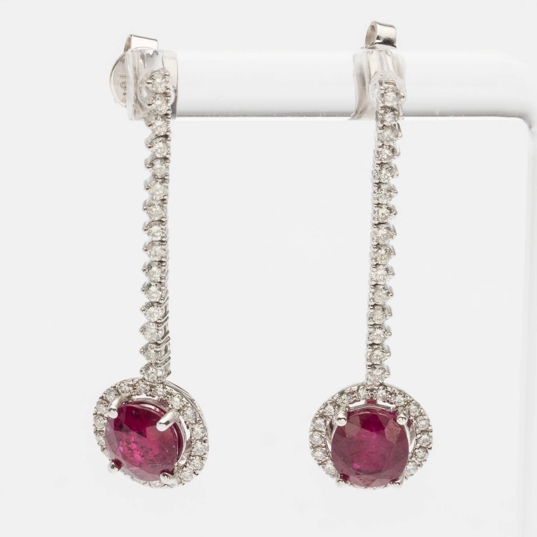 Ruby and Diamond 14K Drop Earrings: Description: Ruby and Diamond 14K Drop Earrings, each featuring a round cut ruby (approx. 4 cts total) with diamond halo on a diamond chain (approx. 1.25 grams), set in 14K white gold, marked '14