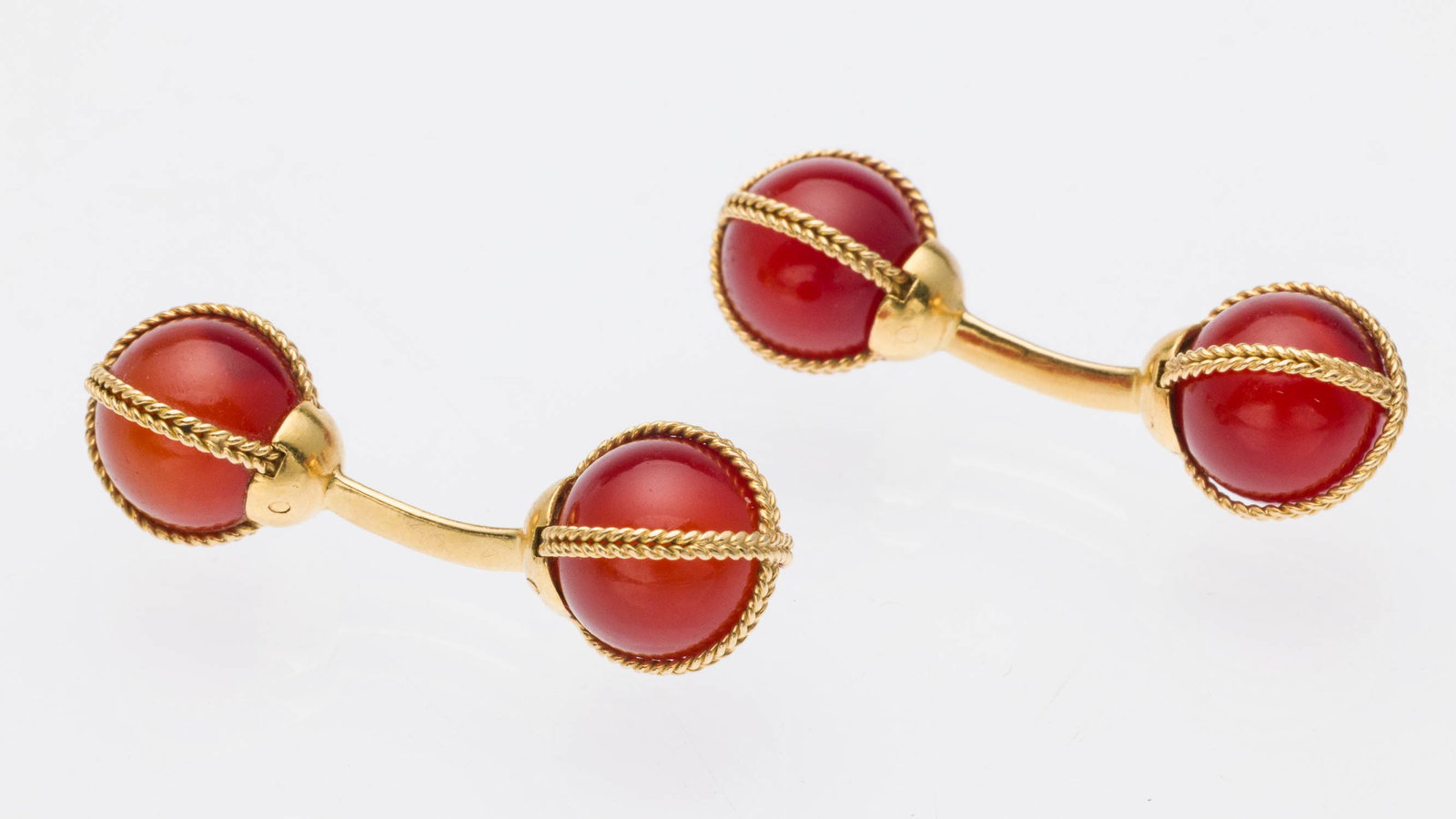 Carnelian and 18K Tiffany Cufflinks: Description: Carnelian and 18K Tiffany Cufflinks, pair of barbell-form cufflinks featuring round carnelians set in 18K yellow gold, marked 'Tiffany & Co, 18KT, France'. 9.5 grams. Measurements: