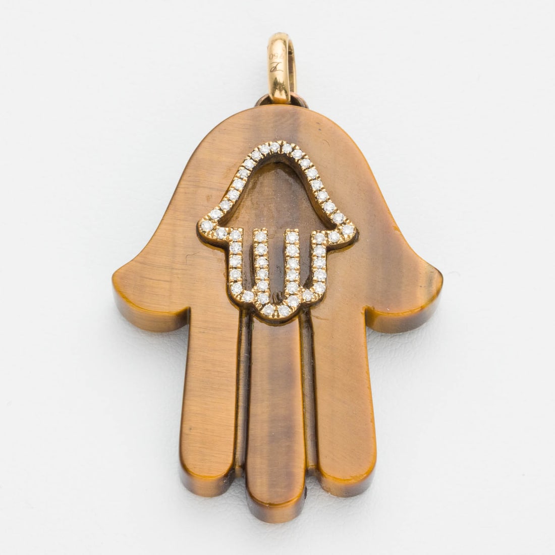 18K Yellow Gold Tiger Eye and Diamond Hamsa Pendant: Description: 18K Yellow Gold Tiger Eye and Diamond Hamsa Pendant, Hamsa-form carved tigers eye pendant accented with yellow gold and diamonds, marked '750, RI' on pendant loop. 12 grams.