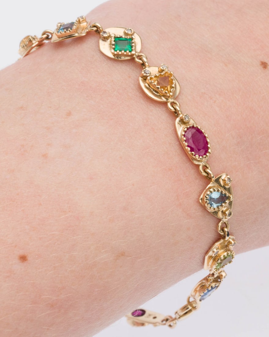Butterfly Multi-Gem 14K Line Bracelet: Description: Butterfly Multi-Gem 14K Line Bracelet, featuring various faceted and cabochon colored gemstones and small round accent diamonds set in 14K yellow gold with claw clasp, marked '585' on