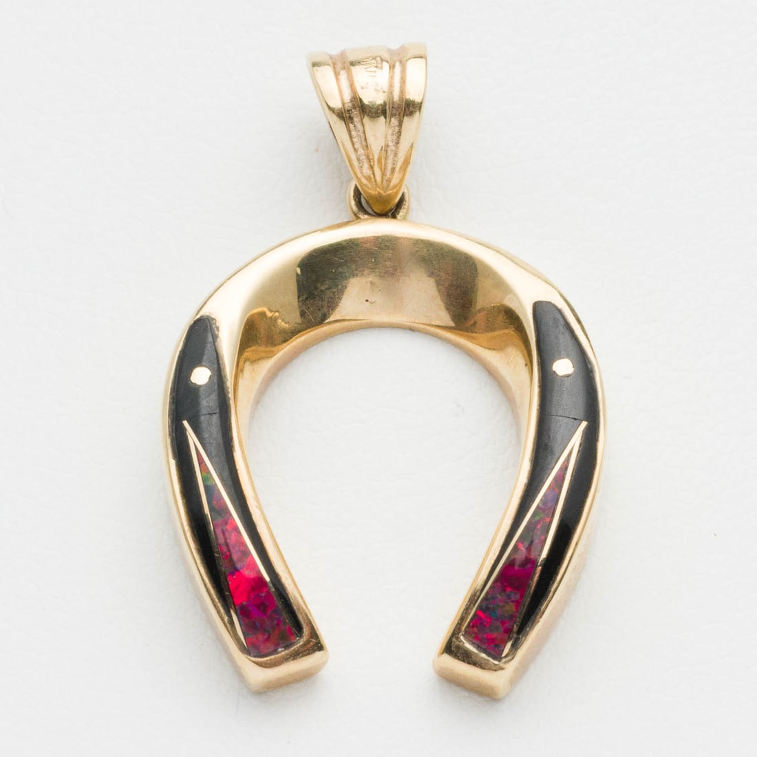 14K Gold, Onyx and Red Opal Horseshoe Pendant: Description: 14K Gold, Onyx and Red Opal Horseshoe Pendant, yellow gold horseshoe pendant inlaid with red opal and onyx, marked '14K' on pendant loop. 6.68 grams overall. Measurements: Height: 1 1/8