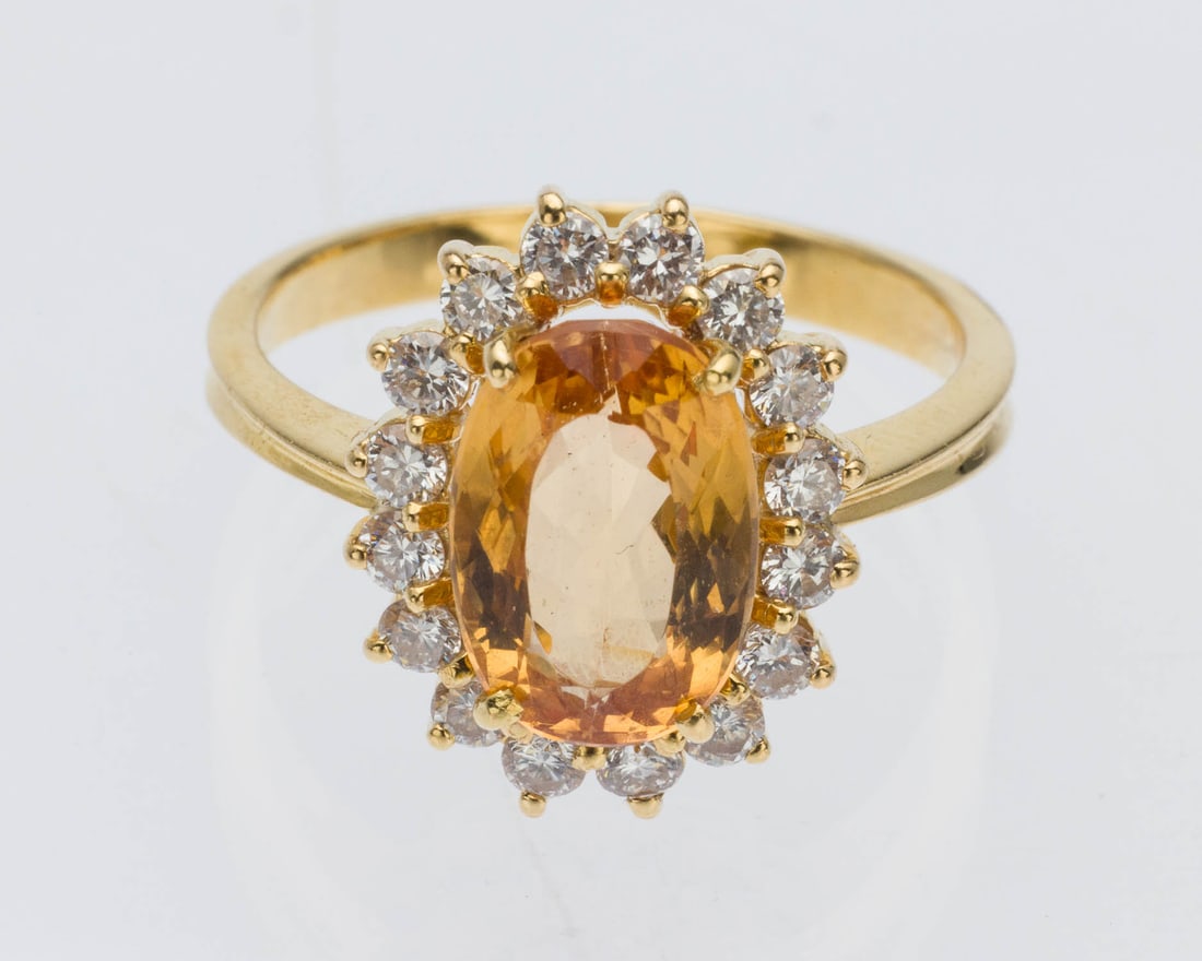 Imperial Topaz, Diamond and 18K Gold Ring, Size 6.25: Description: Imperial Topaz, Diamond and 18K Gold Ring, Size 6.25, featuring an oval cut imperial topaz (approx. 3-4 cts) prong set with round diamond halo (approx. 0.50 cts) set in a yellow gold
