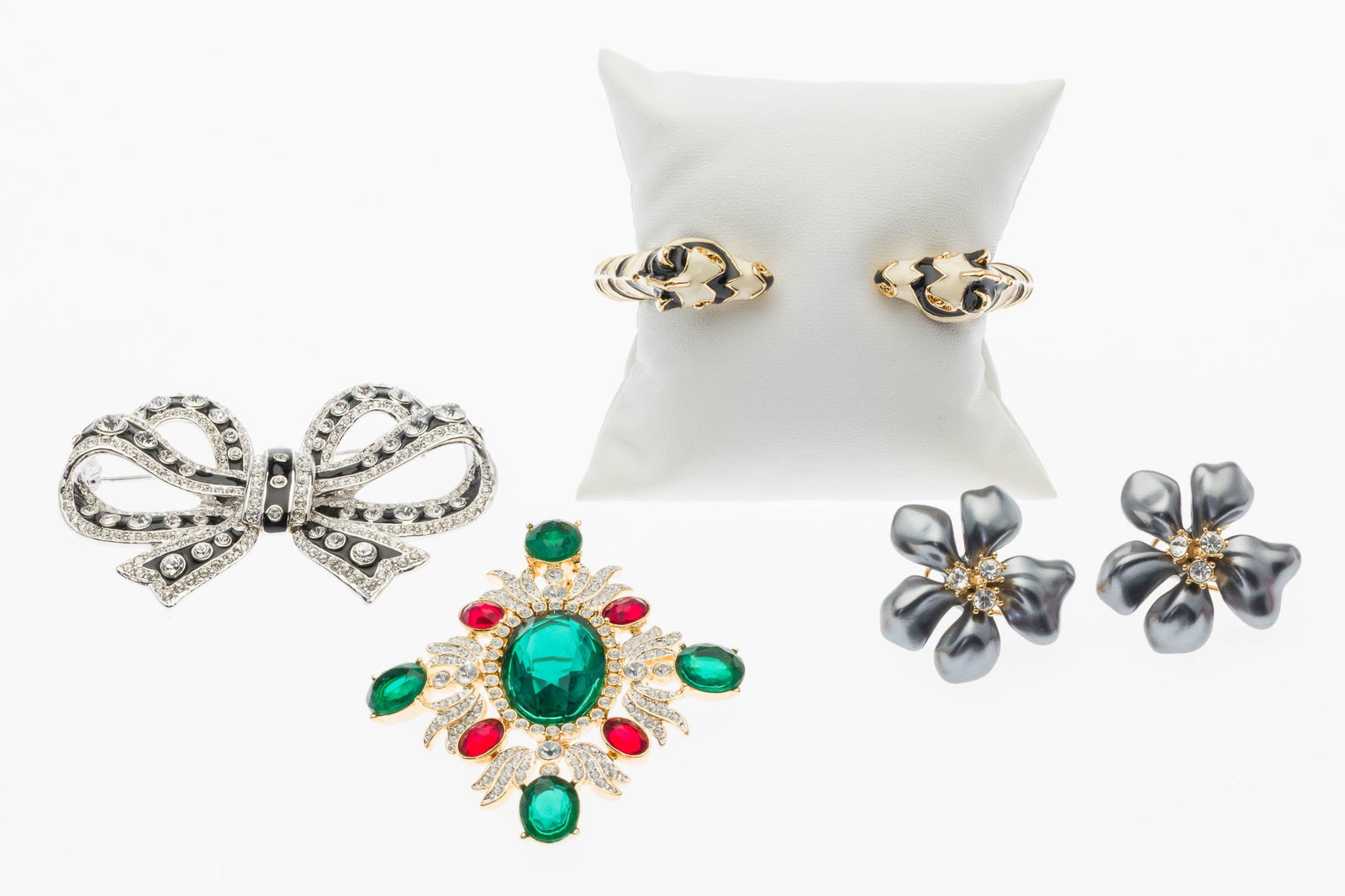 Group of Kenneth Jay Lane Jewelry, 4 pcs.: Property from a Private Collection, Savannah, GA Description: Group of Kenneth Jay Lane Jewelry, 4 pcs., comprising two brooches, a giraffe cuff bracelet, and a pair of pearl-style flower earrings,