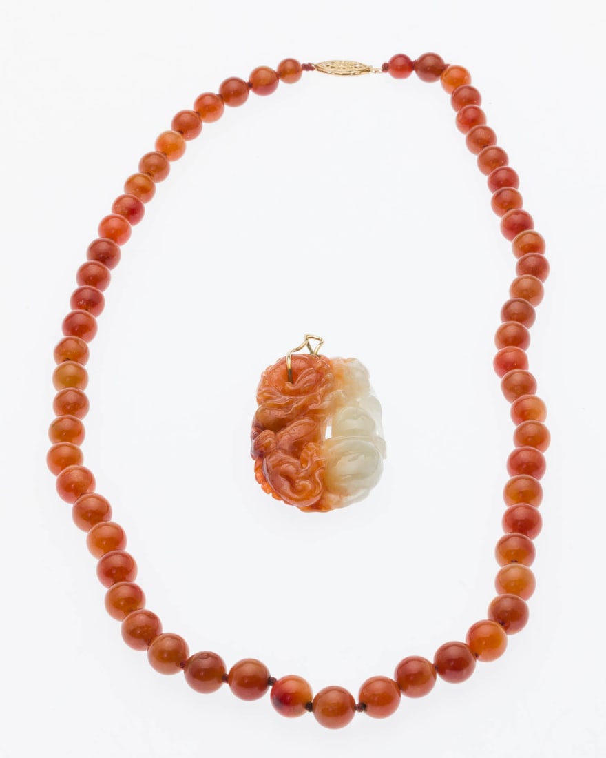 Chinese Orange Jade Necklace with Pendant: Property of a Private Collector, Savannah, GA Description: Chinese Orange Jade Necklace with Pendant, a 21 in. orange jade beaded necklace with 14K yellow gold clasp, and a carved orange and white
