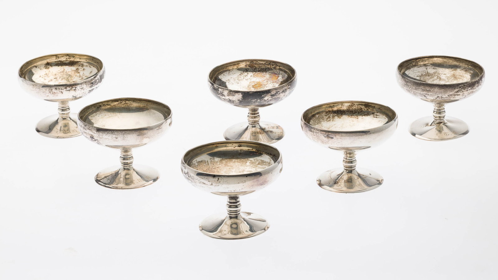 6 Sterling Silver Sherberts: Property from a Private Collector, Savannah, GA Description: 6 Sterling Silver Sherberts, each on a footed base with monogram, with pictorial mark and 'sterling' on underside. 18.46 troy ounces.