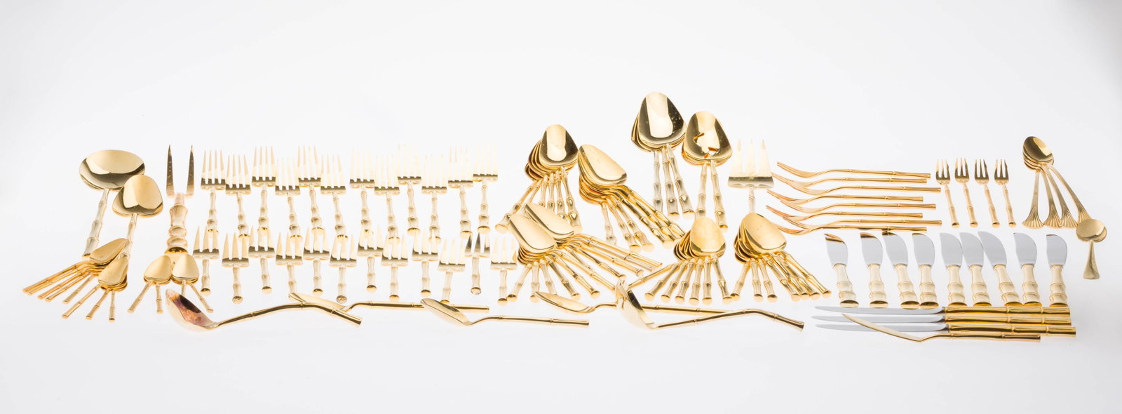 Set Gold Plated Stainless Bamboo Flatware, 117 pcs: Property of a Private Collector, Savannah, GA Description: Set of Gold Plated Stainless Bamboo Flatware, 117 pcs., comprising 12 dinner knives, 12 dinner forks, 12 dessert forks, 12 table spoons, 25