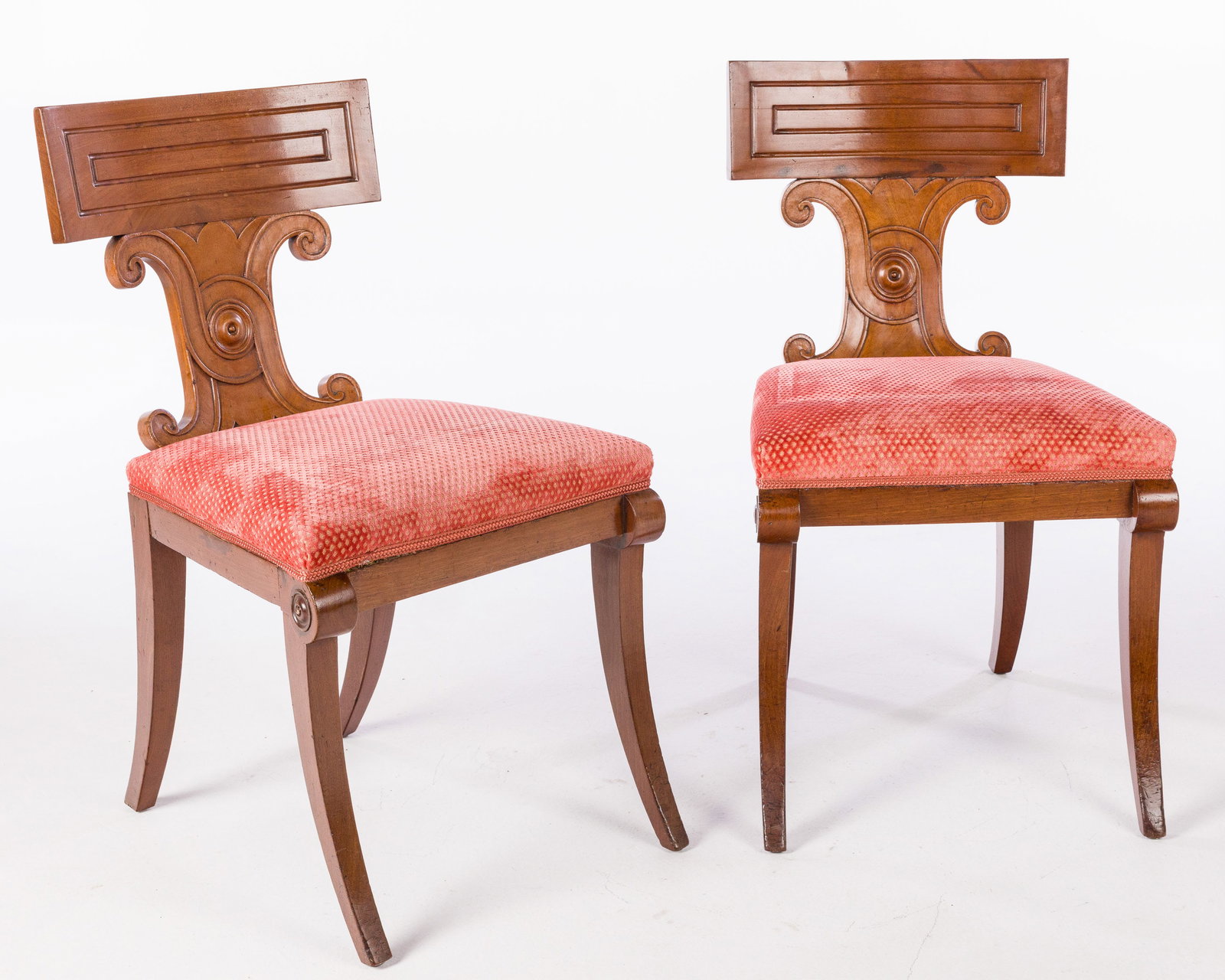Pr Regency Mahogany Hall Chairs, 1st Quarter 19th C: Property of a Private Collector, Savannah, GA Description: Pair of Regency Mahogany Hall Chairs, 1st Quarter 19th C, each with carved back above an overupholstered seat raised on sabre legs. Measureme