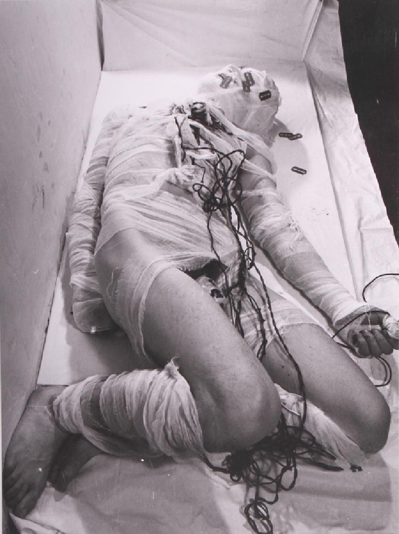 Rudolf Schwarzkogler (1940-1969) Austrian: UNTITLED (Reclining Mummy with Razor Blades and Wire), 1965, gelatin silver print 15 ½ x 11 ¾”, mounted to card 25 ½ x 19 ½”, artist’s estate stamp and authorized
