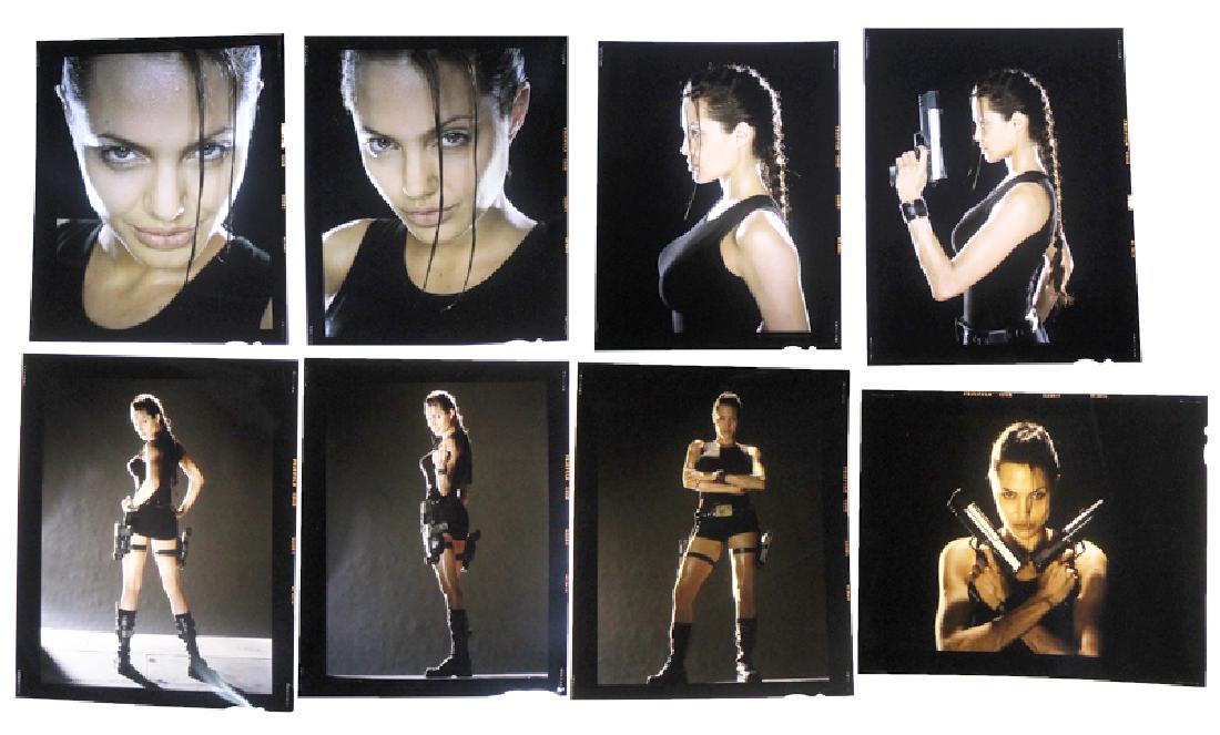 David LaChapelle (b. 1963) New York (eight): Angela Jolie as Laura Croft the Tomb Raider, eight original color transparencies, each with title and credit stickers, each 4 x 5â€. (8)