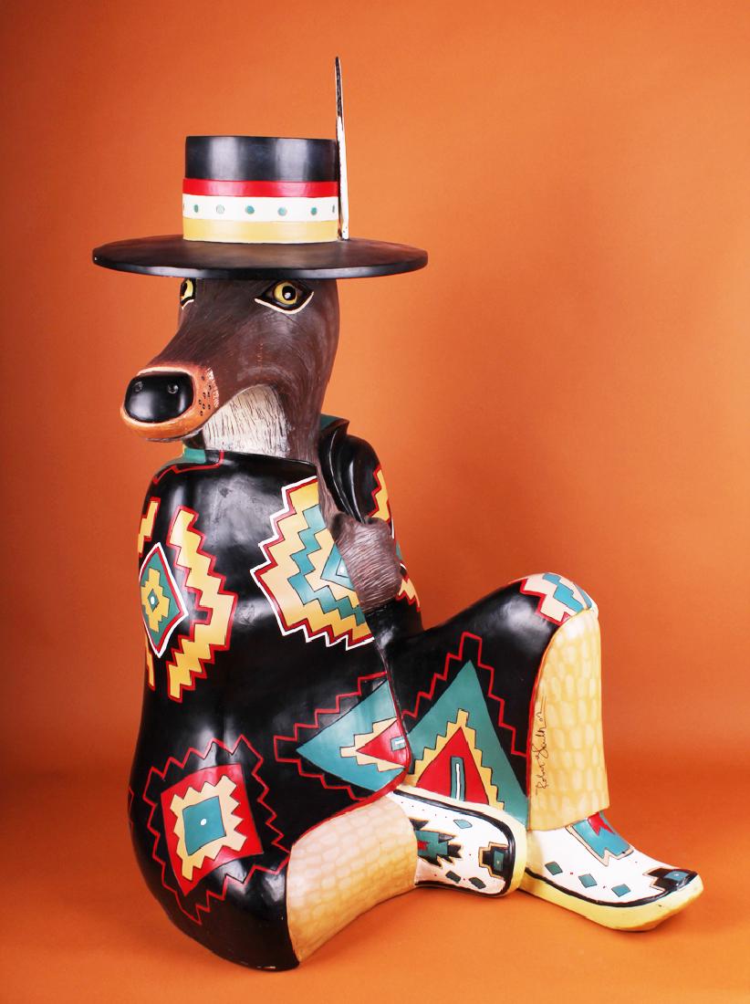 Southwestern Art: Robert Shields (b. 1951) California/: COYOTE TRICKSTER, 2002, incised and painted wood or composite, signed and dated in marker, 42 x 30 x 22â€.