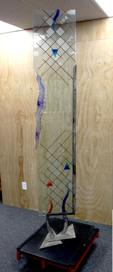 Greg Schad (20th Century) American, UNTITLED, sculpture: Greg Schad (20th Century) American, UNTITLED, sculpture with a 1â€ thick clear and colored glass slab with incised patterns and appliques, with stylized L shaped brushed steel support and metal leg