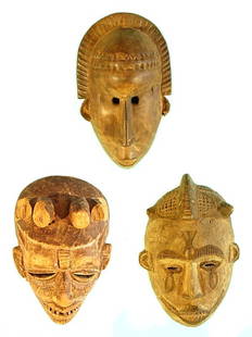 African Masks (three): A hand carved and partially painted wood mask with individually carved teeth, 9 ½" tall, 6 ½" wide, holes for rope; BAMBARA MALI MASK, a carved wood mask, 12" tall, 7 ½" wide, holes for rope,