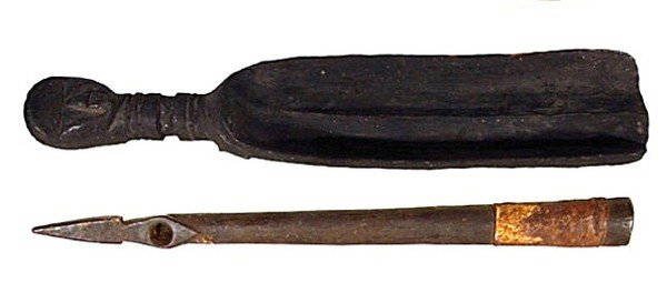 African Sculptures (two): MANO LIBERIA, carved wood scoop with figural head handle, 20" long, 4" wide, 2" deep, natural wear associated with age, otherwise in good condition; Carved wood pipe, 24" long, 2" diameter, loss at